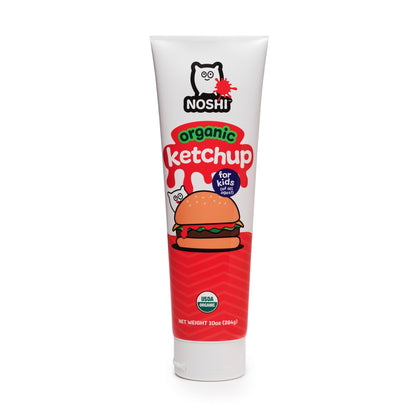 Standing tube of Noshi Organic Ketchup for kids featuring an illustration of a cute round character about to eat a hamburger